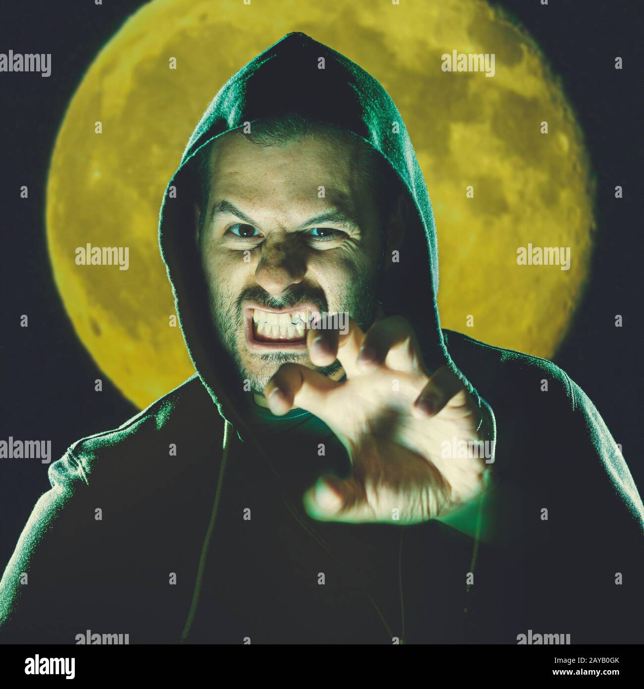 Scary man before full moon in a night scene. Stock Photo