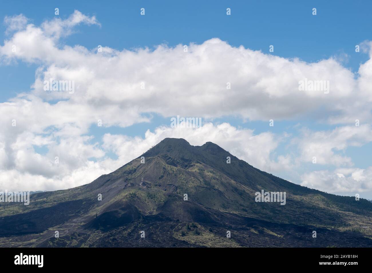 Mount Agung volcano against a blue sky Stock Photo