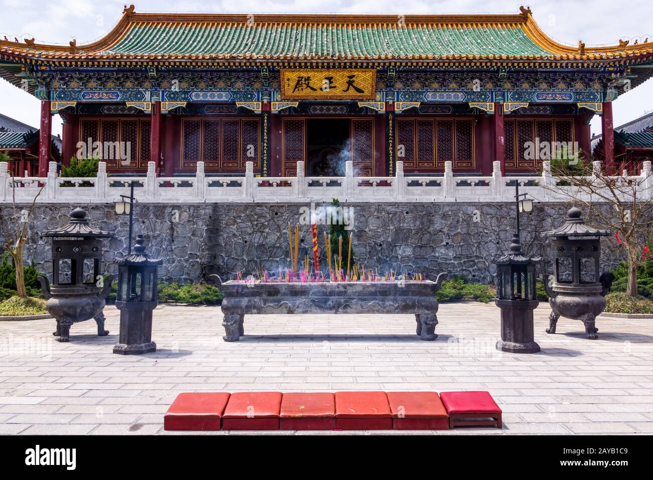 Smoking incenses in front of the Tianmenshan temple on top of Tianmen Mountain Stock Photo