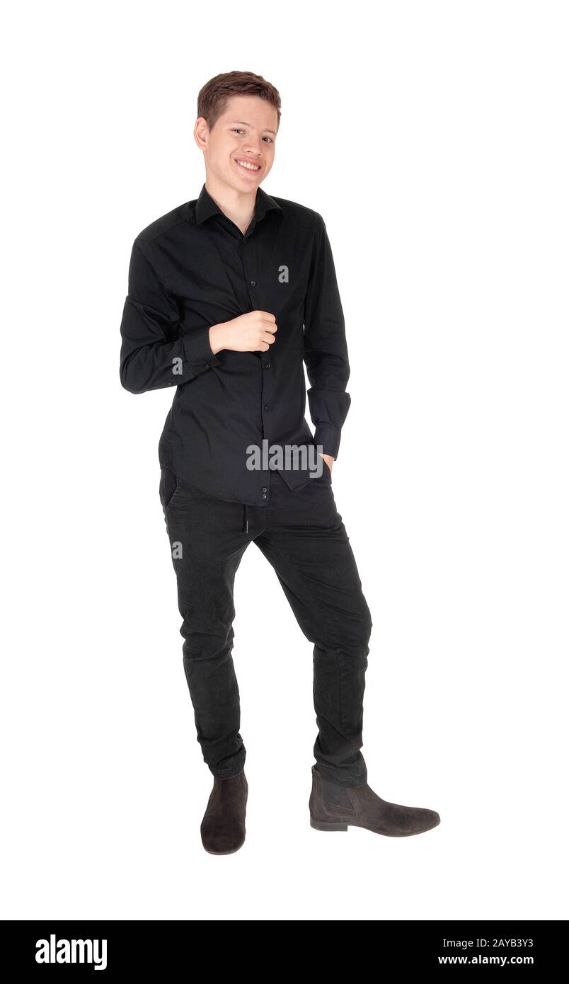 Young handsome teenager boy standing in a black outfit Stock Photo