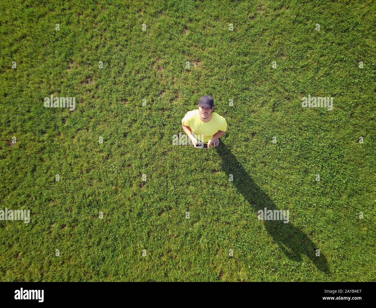 Adult young man is controlling his drone and taking some photos and videos. Aerial top view, technol Stock Photo