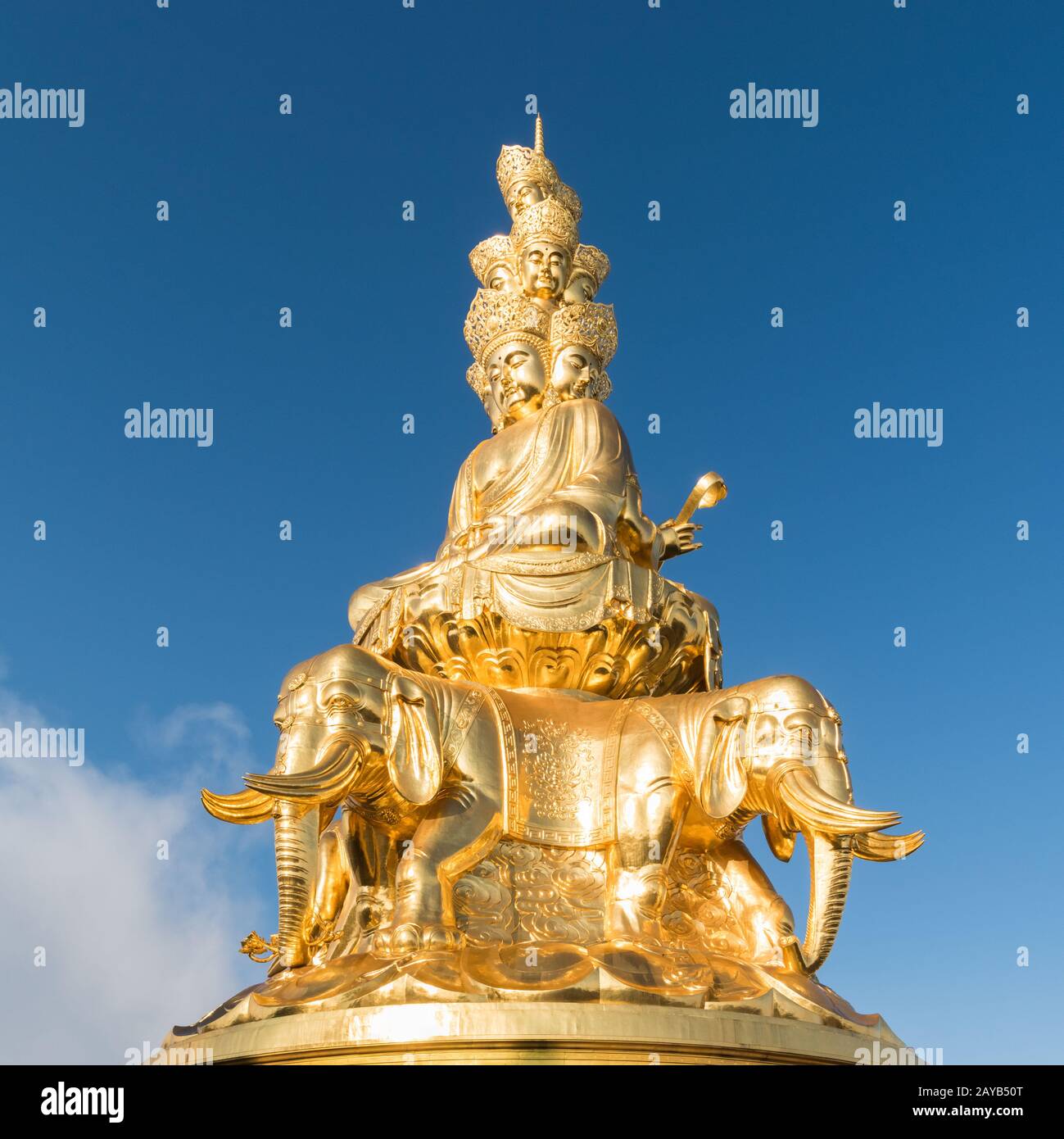 gold buddha against a blue sky Stock Photo