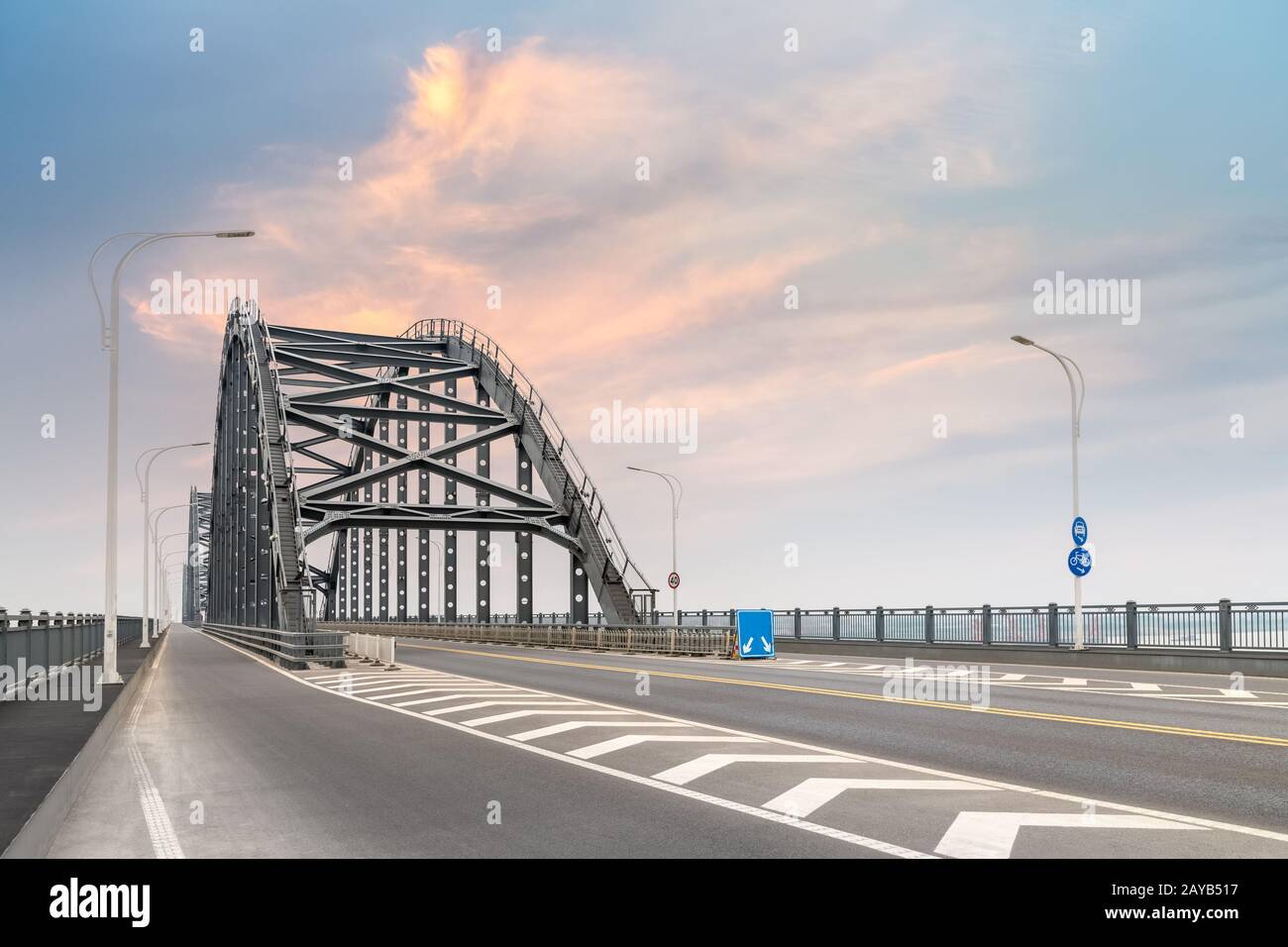 steel bridge and road with sunset sky Stock Photo