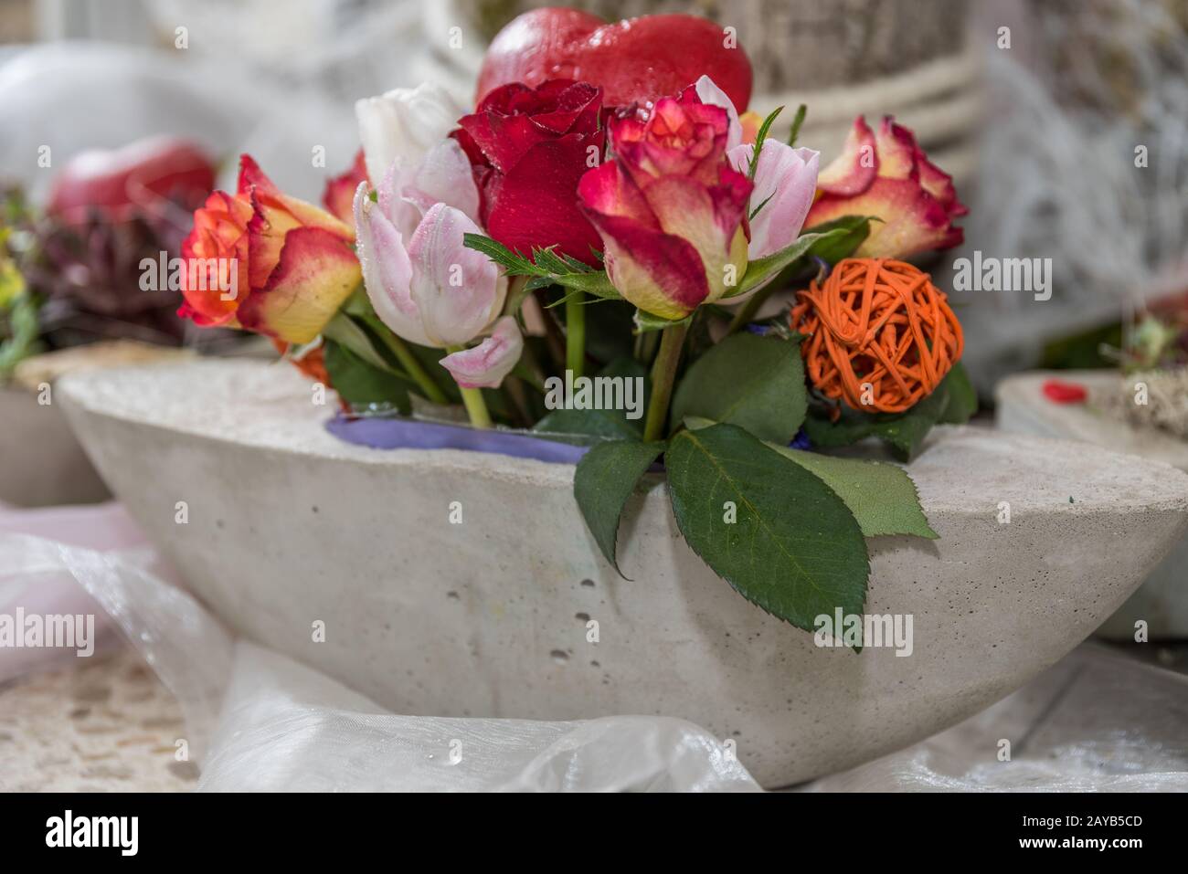 creative rose decoration in concrete shell - close-up of floristry Stock Photo