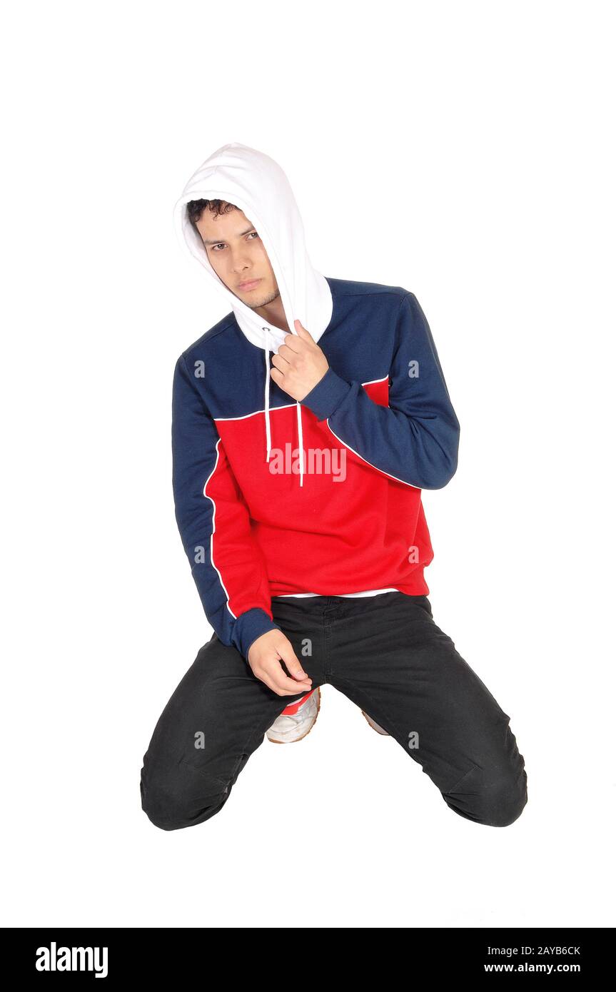 Happy young man kneeling on the floor resting from exercise Stock Photo