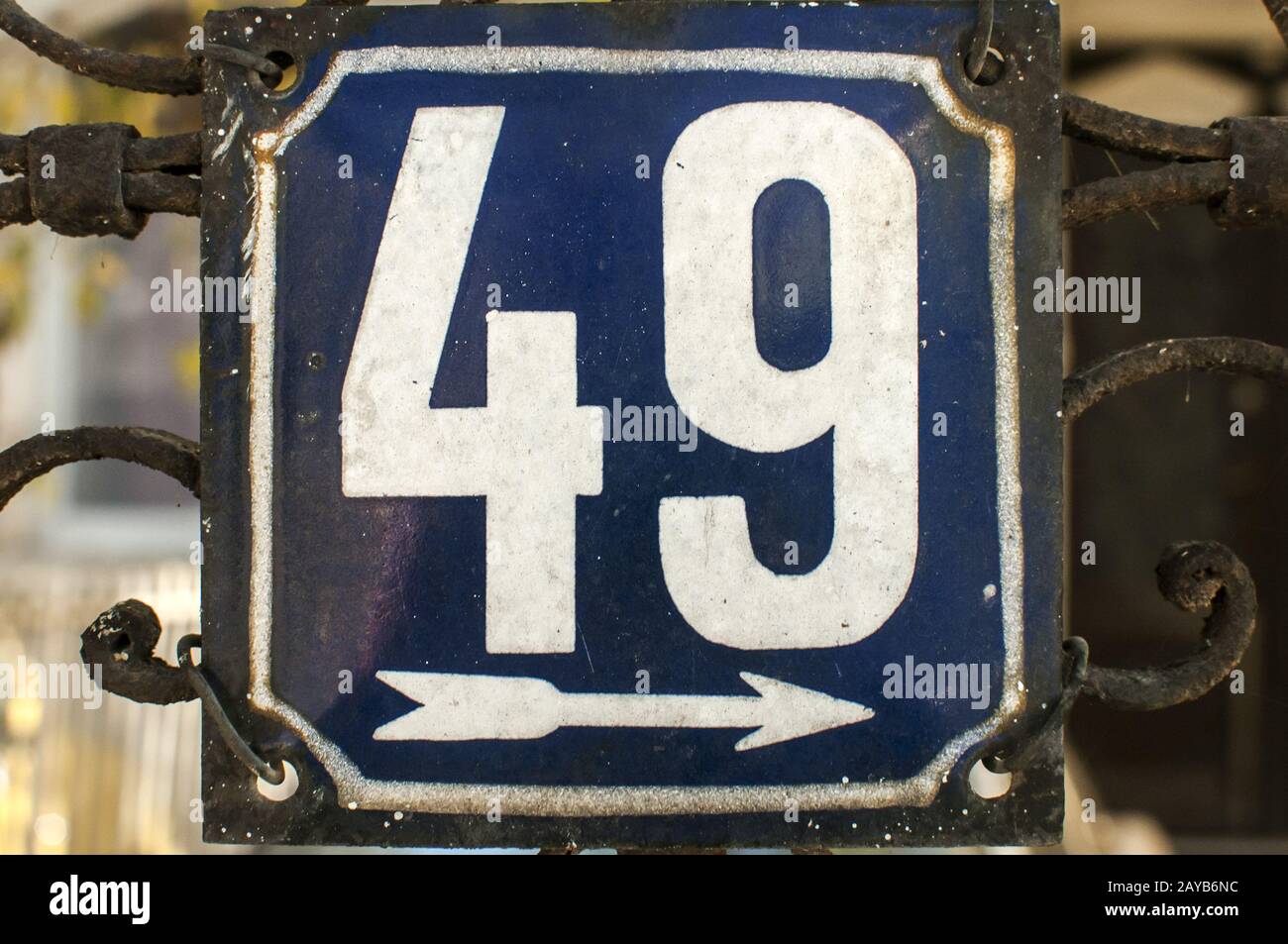 Weathered grunge square metal enameled plate of number of street address with number 49 closeup Stock Photo
