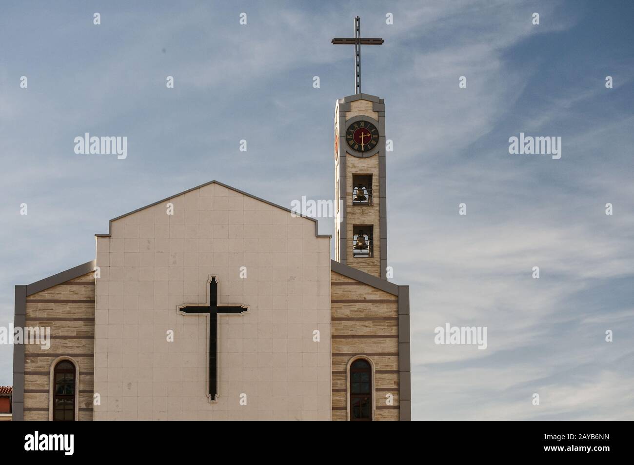 Contemporary catholic church building with bell tower and clock tower Stock Photo