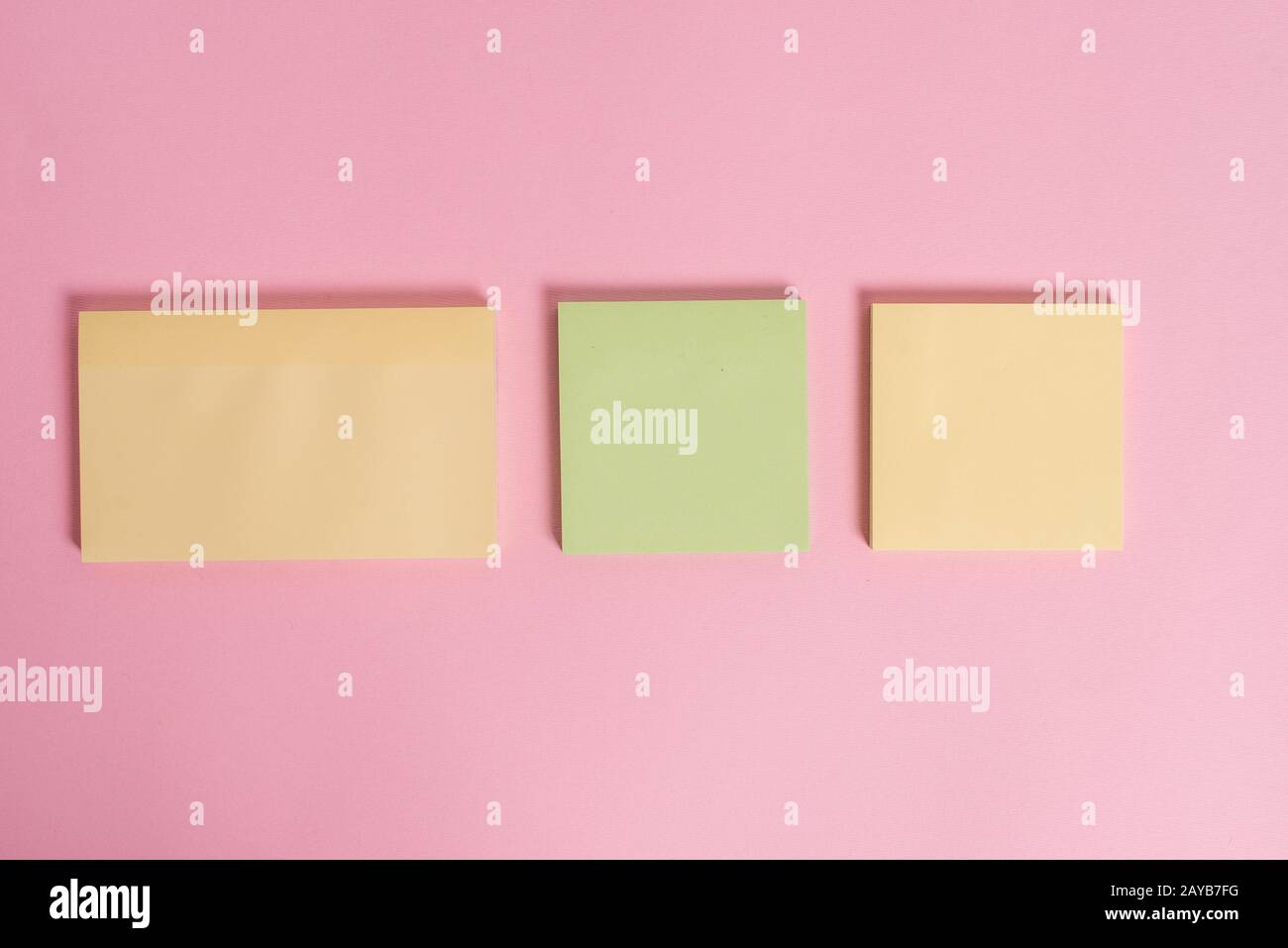 Closeup front view three multicolor blank notepads message sticky notes colored background empty text important events home offi Stock Photo