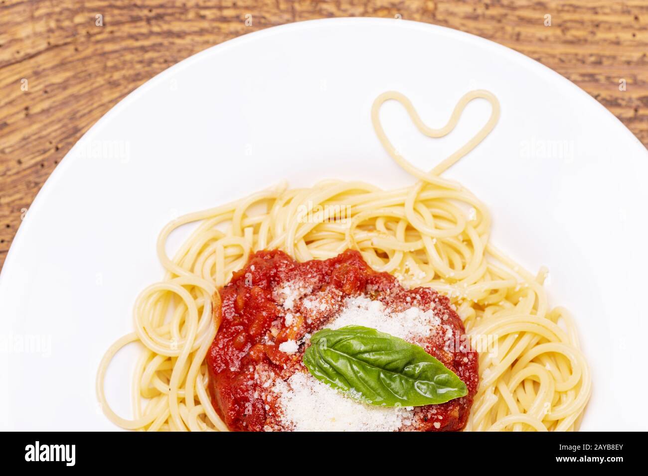 Spaghetti heart on dark wood Stock Photo Alamy