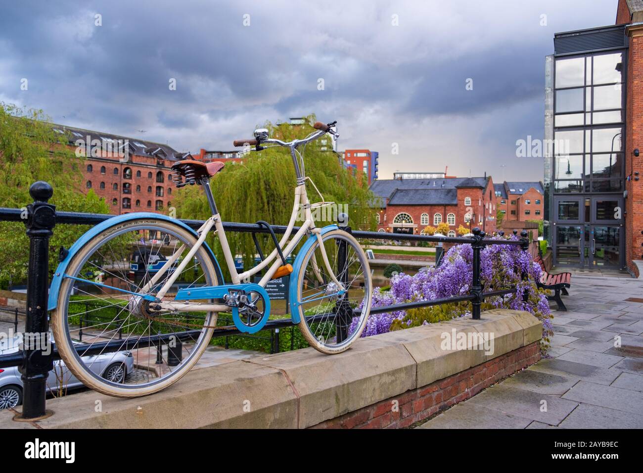 Atmospheric scene  of a parked bicycle at the restored Victorian canal system in Castlefield area of Manchester Stock Photo