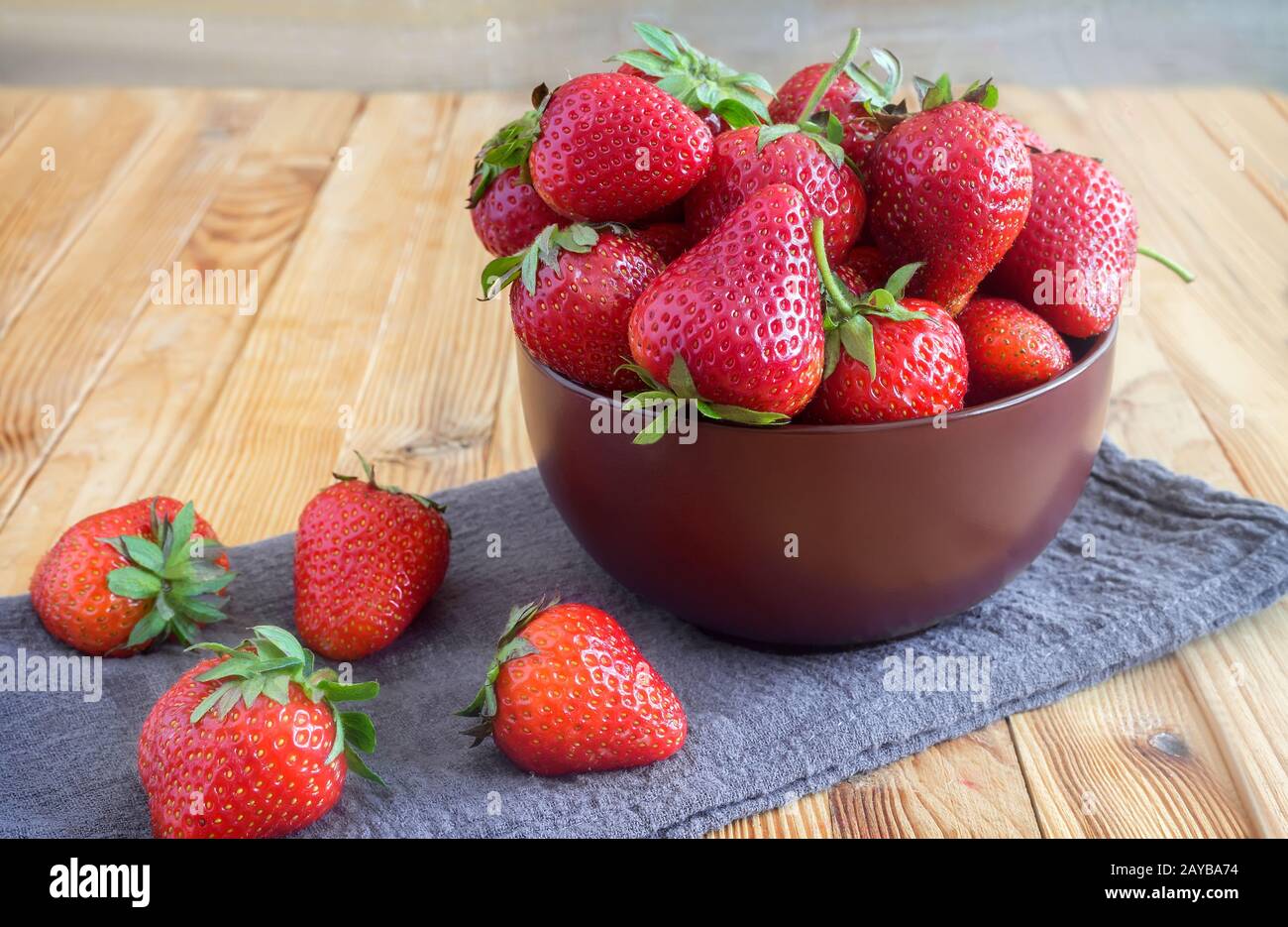 Strawberries on the table in a ceramic bowl. Stock Photo