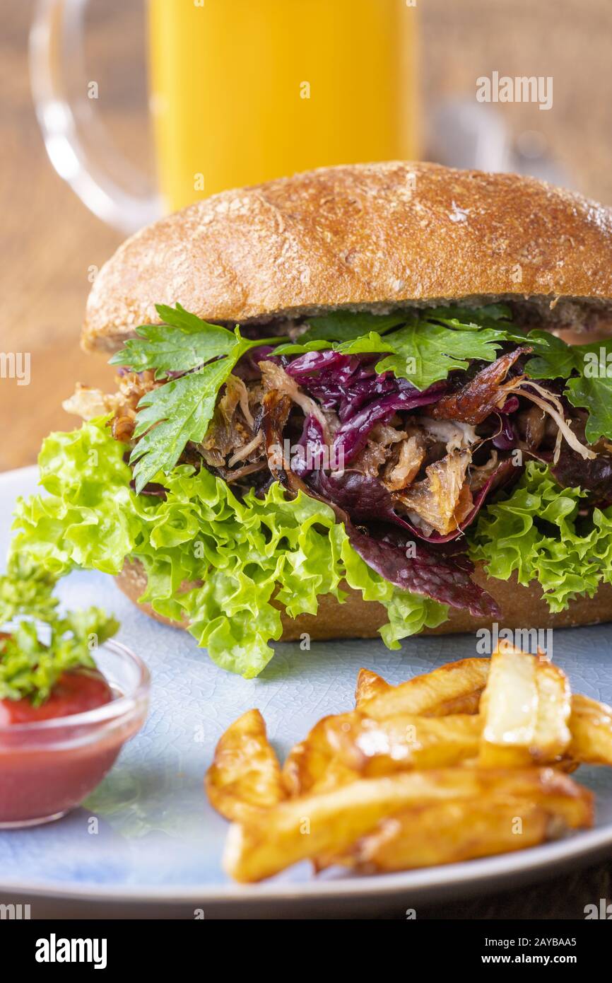 Pulled Pork in a roll with beer Stock Photo