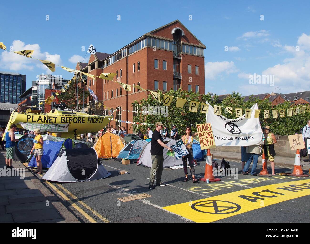 extinction rebellion protesters blocking thee road at victoria bridge in leeds west yorkshire holding signs and banners Stock Photo