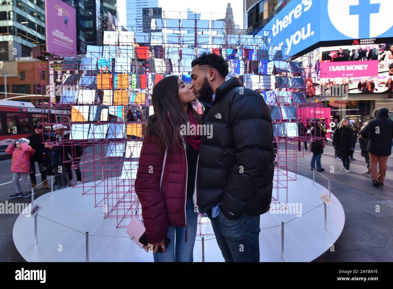 (L-R) Kimberly Sookra and Sage Raghoonanan, both from Queens, kiss on Valentine’s Day in front of the “Heart Squared” sculputre by artists MODU and Eric Forman Studio, part of the Times Square Alliance celebration of Valentine’s in Times Square, in New York, NY, February 14, 2020.  (Photo by Anthony Behar/Sipa USA) Stock Photo