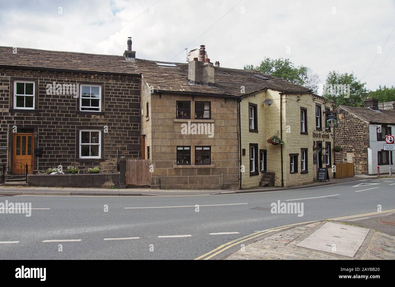 street corner in the old village centre in mytholmroyd west yorkshire with traditional stone houses and the shoulder of mutton p Stock Photo