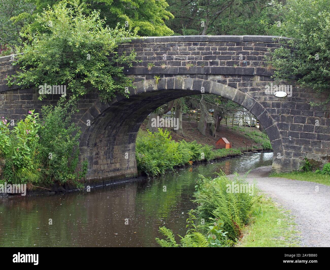 an old stone bridge crossing the rochdale canal at mytholmroyd west