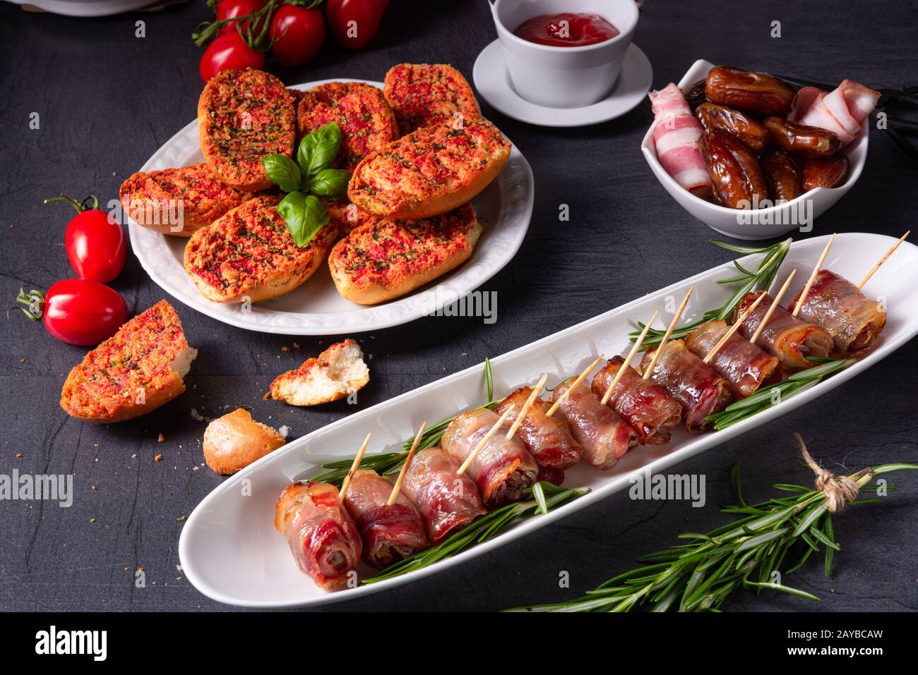 dates wrapped in bacon and delicious tapas Stock Photo Alamy