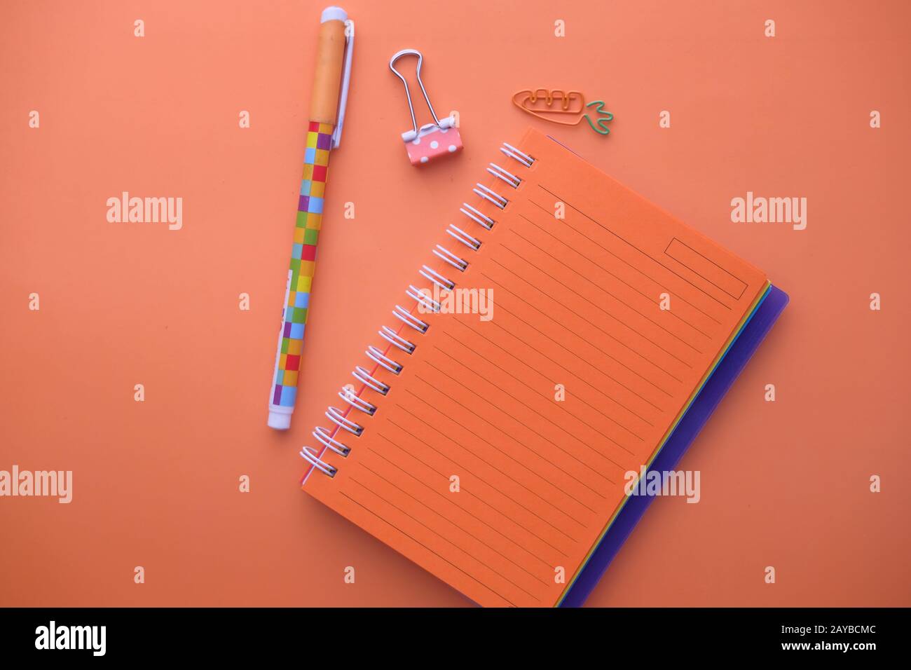 top view of notepad and pen on orange background  Stock Photo