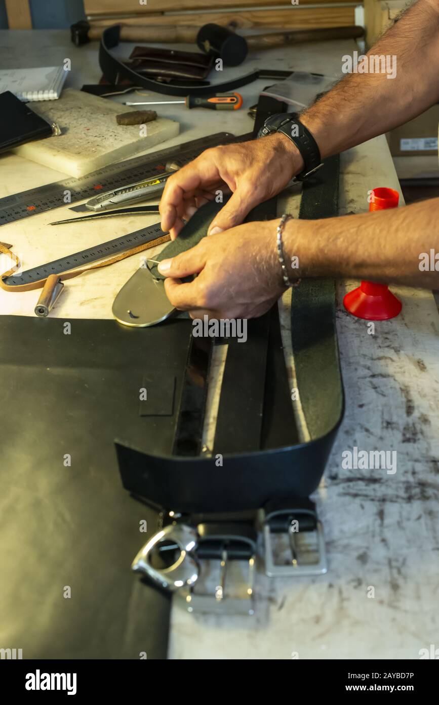 Tailor process leather in workshop. Stock Photo