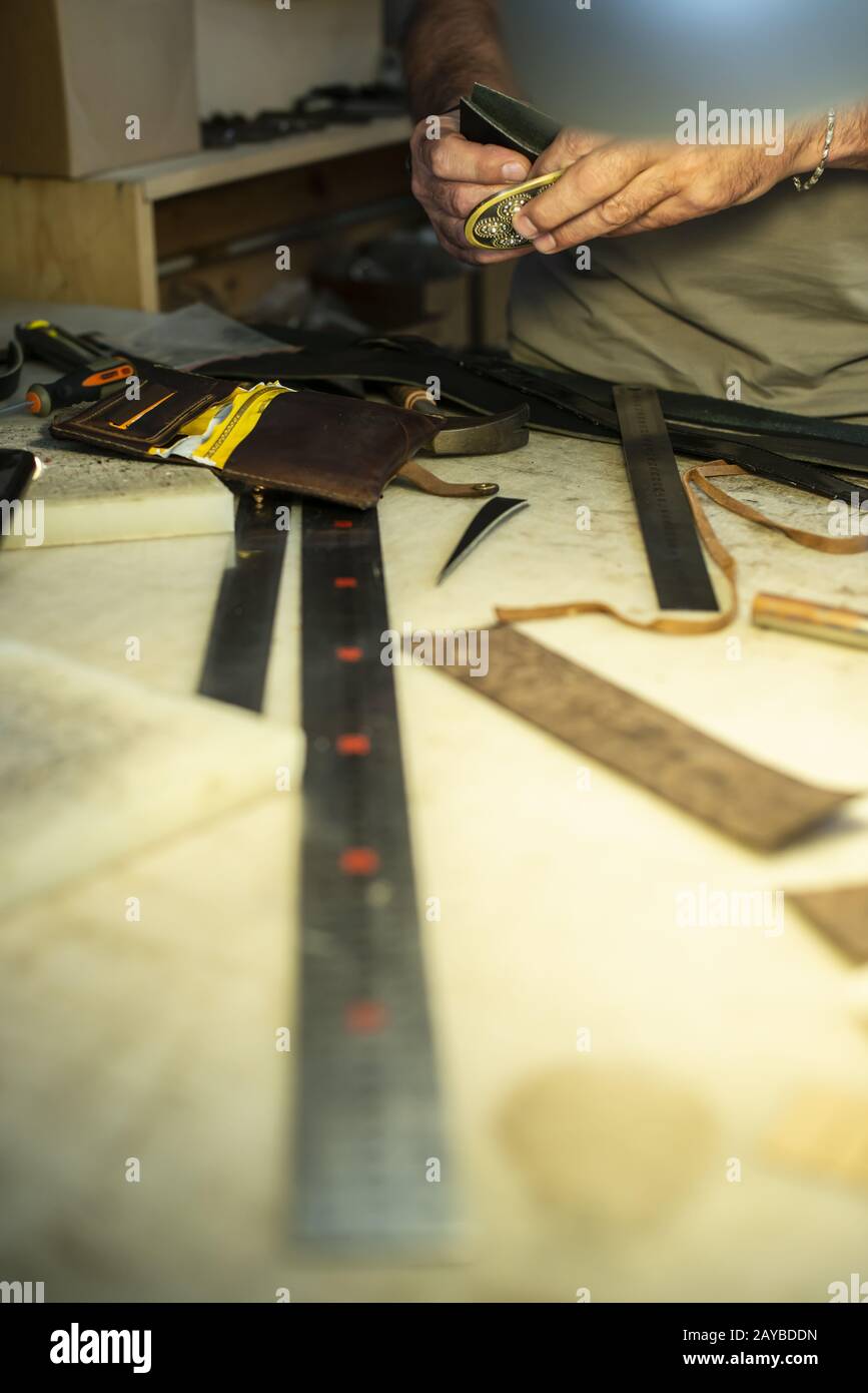 Tailor process leather in workshop. Stock Photo