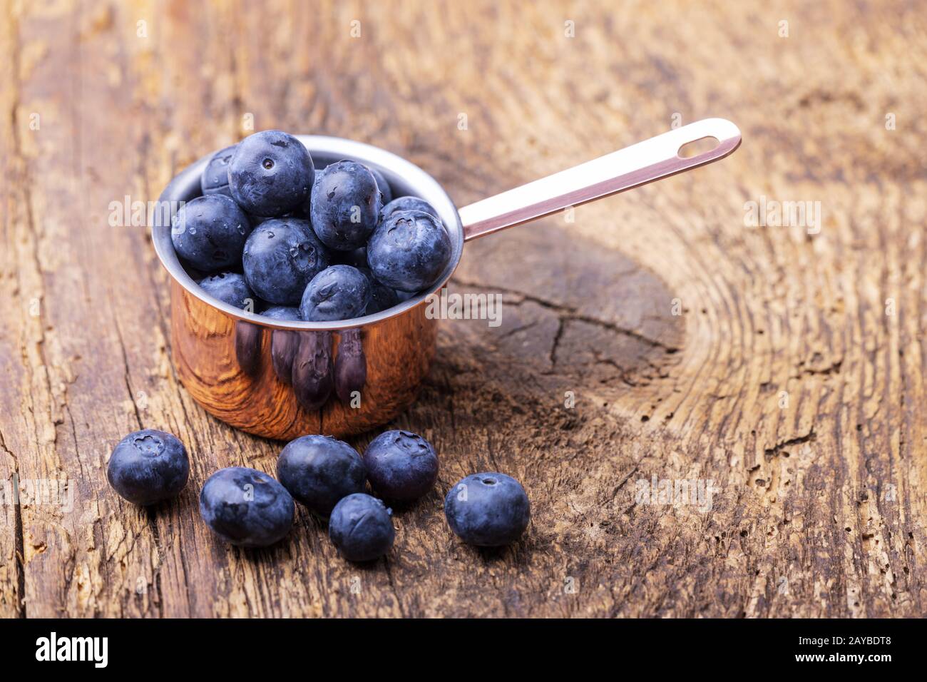 Blueberries in pot on wood Stock Photo