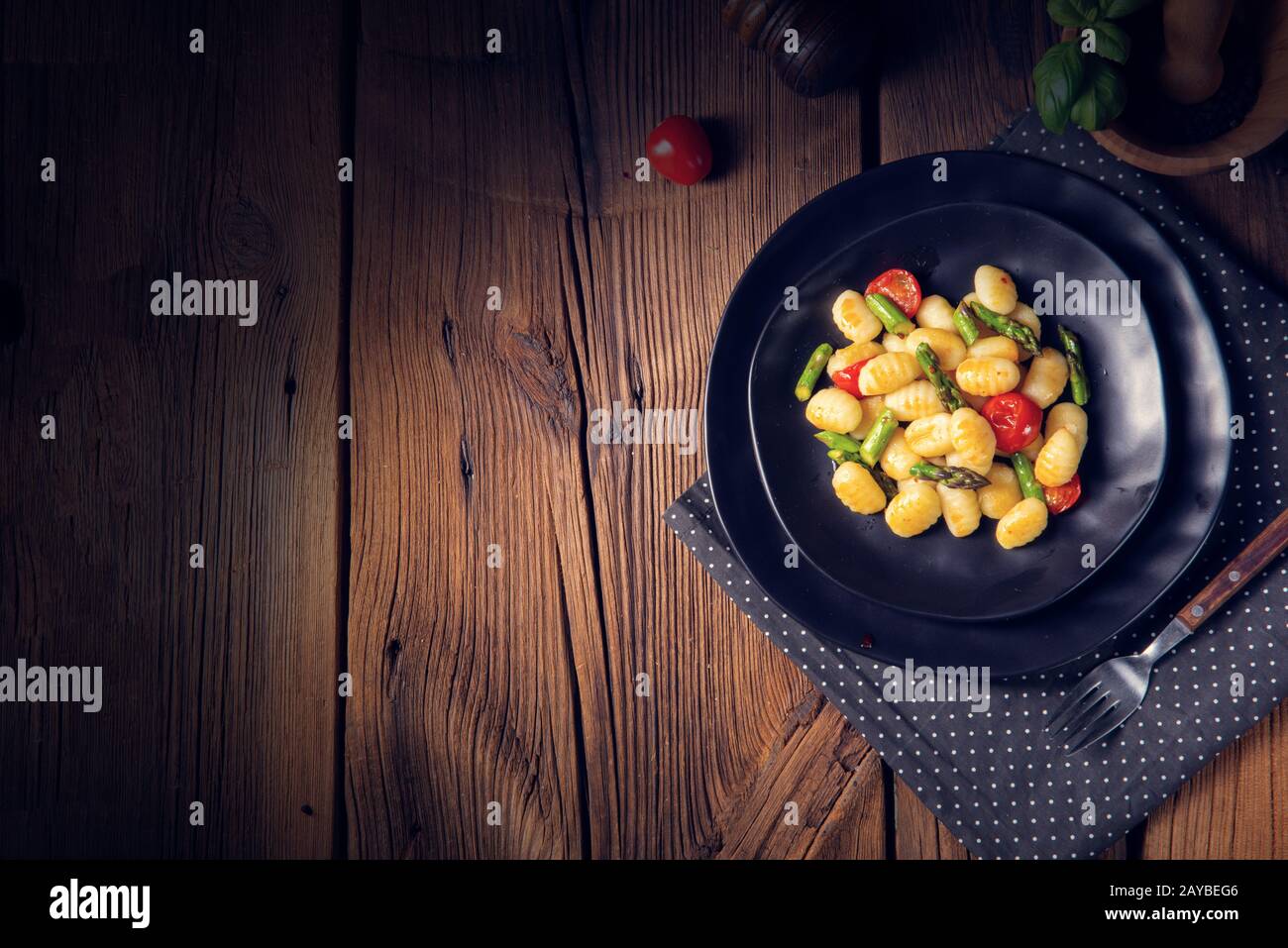crispy gnocchi with roasted asparagus and tomatoes Stock Photo Alamy