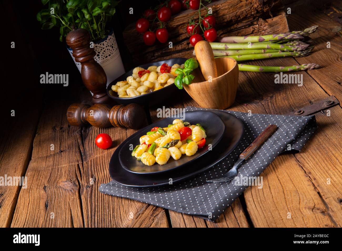 crispy gnocchi with roasted asparagus and tomatoes Stock Photo Alamy