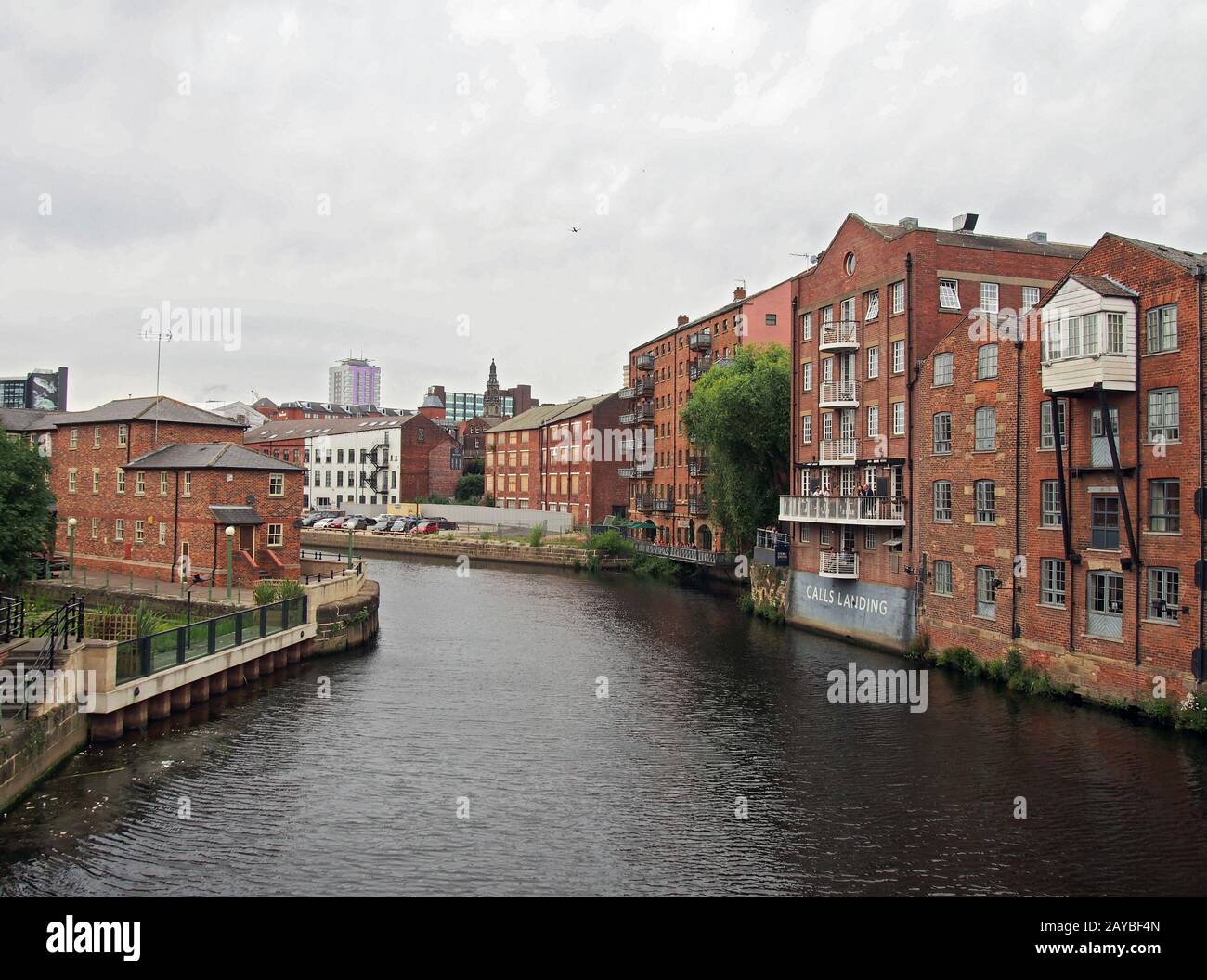 riverside view of the calls landing area of leeds with waterfront apartments and buildings reflected in the river aire Stock Photo