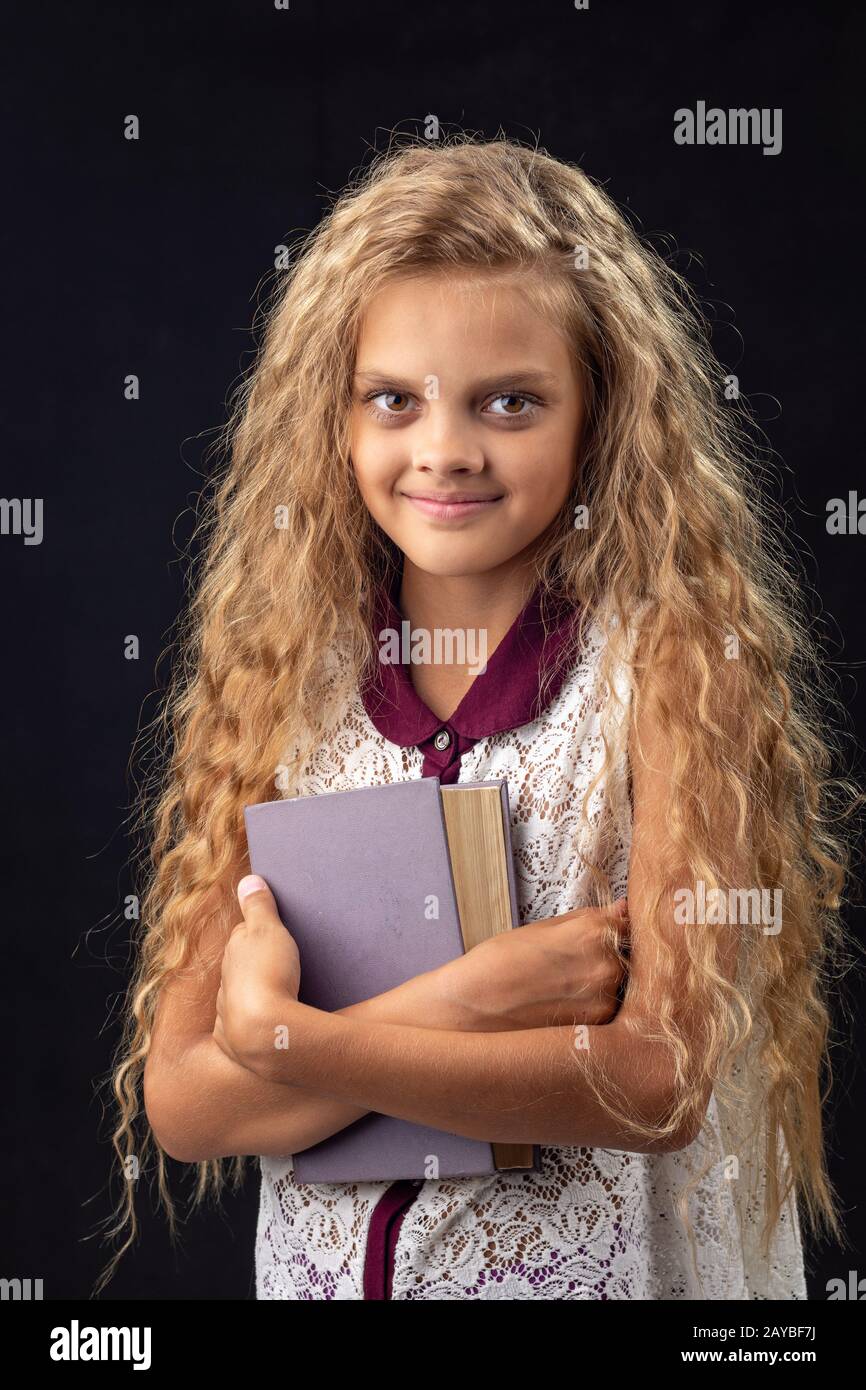 Portrait of a teenage girl with an old book Stock Photo - Alamy