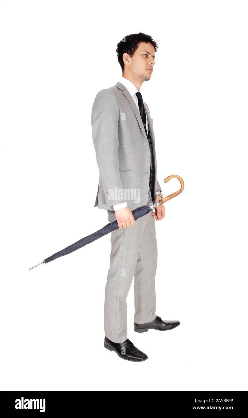 Young handsome man standing with a umbrella in his hands Stock Photo