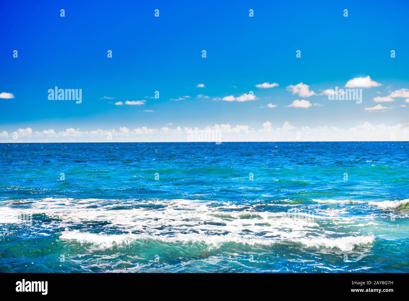 Seascape with blue water, sky and white clouds Stock Photo - Alamy