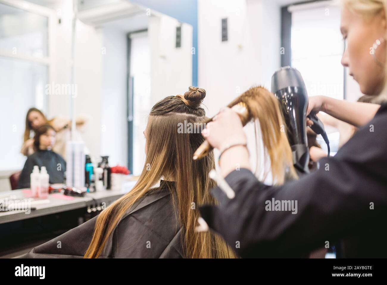 Portrait of happy woman at the hair salon. Professional hair styling ...