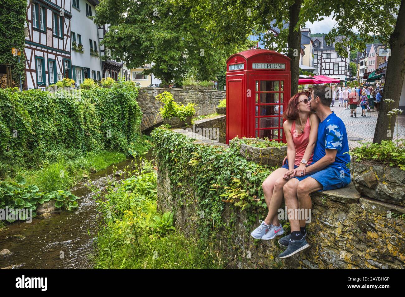 Couple sitting on a wall and kissing Stock Photo