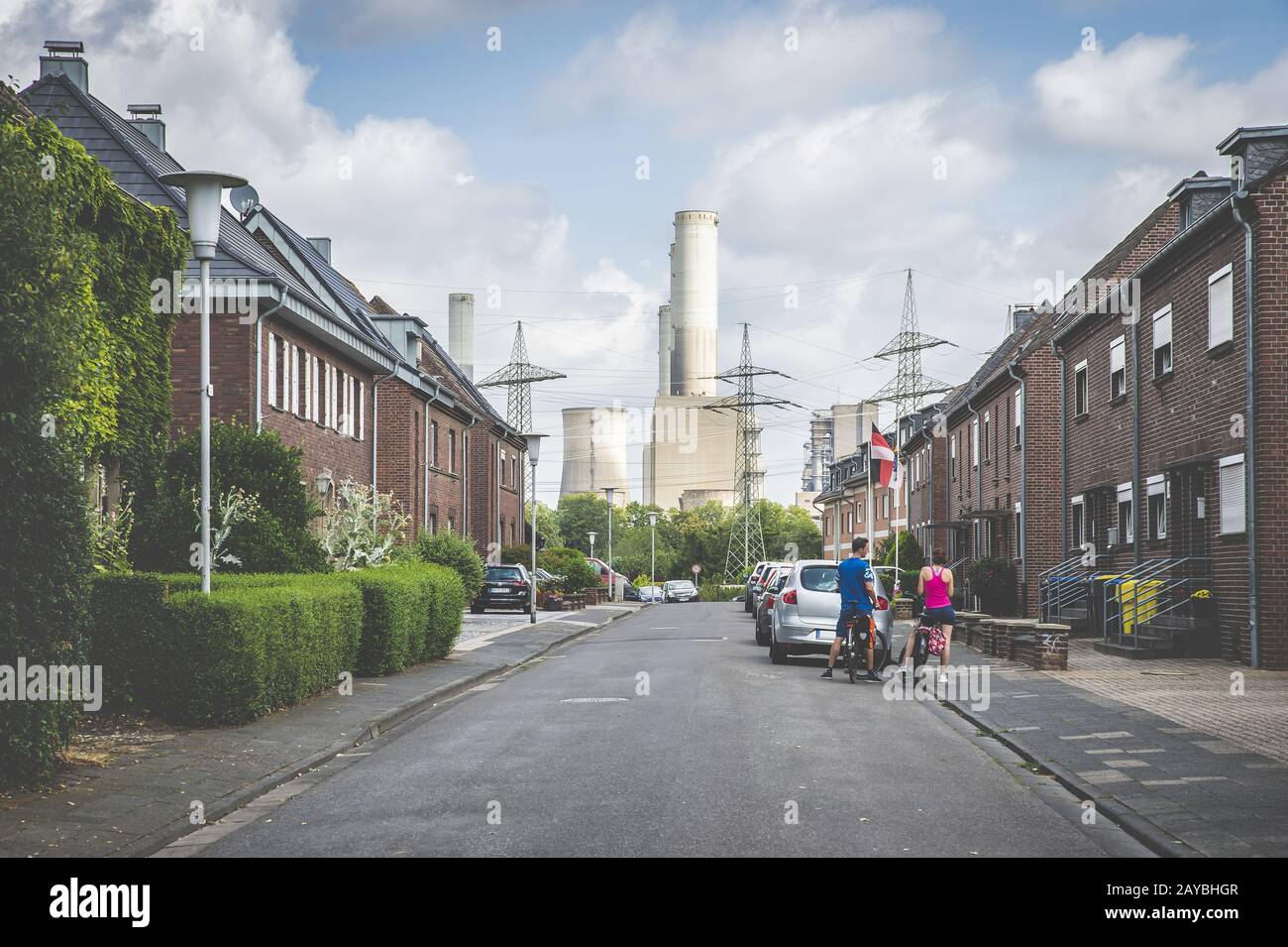 Settlement, houses, old, street, power station, shut down, couple, cyclists, Grevenbroich, North Rhi Stock Photo