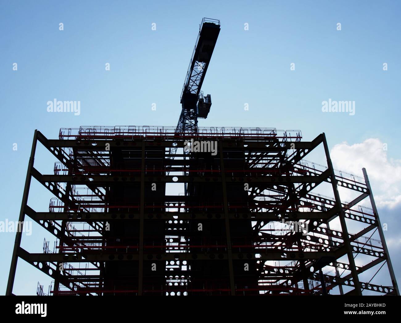 a large construction site in silhouette in the evening with steel girders and a crane in silhouette Stock Photo