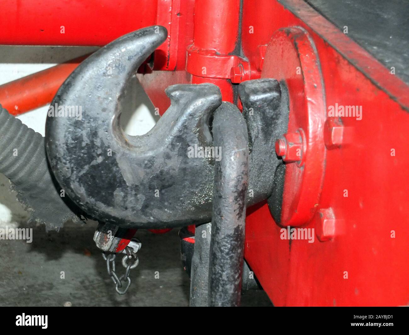 coupling hook from an old steam locomotive painted black on red buffers Stock Photo