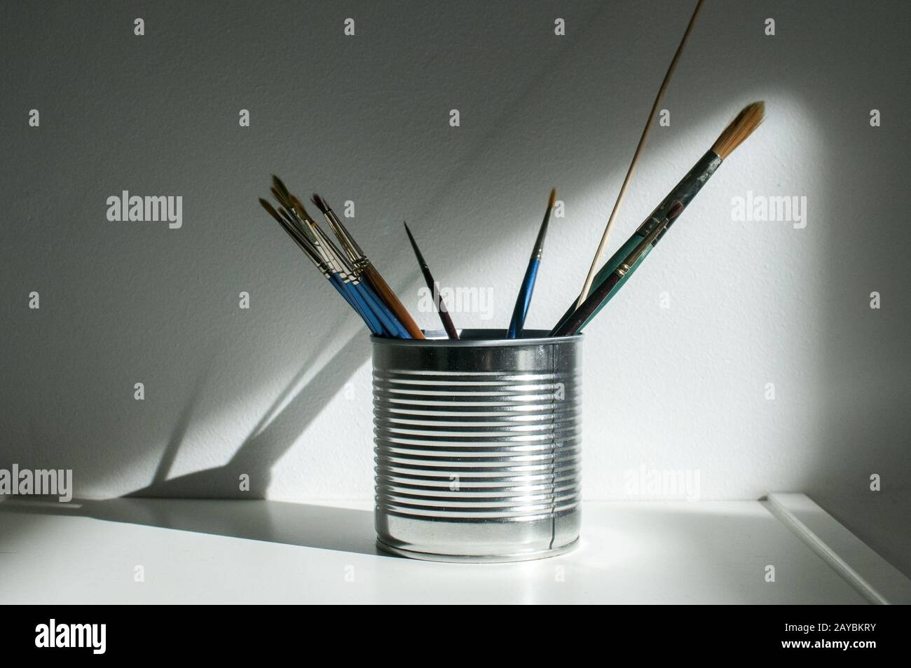 Tin can with paint brushes Stock Photo
