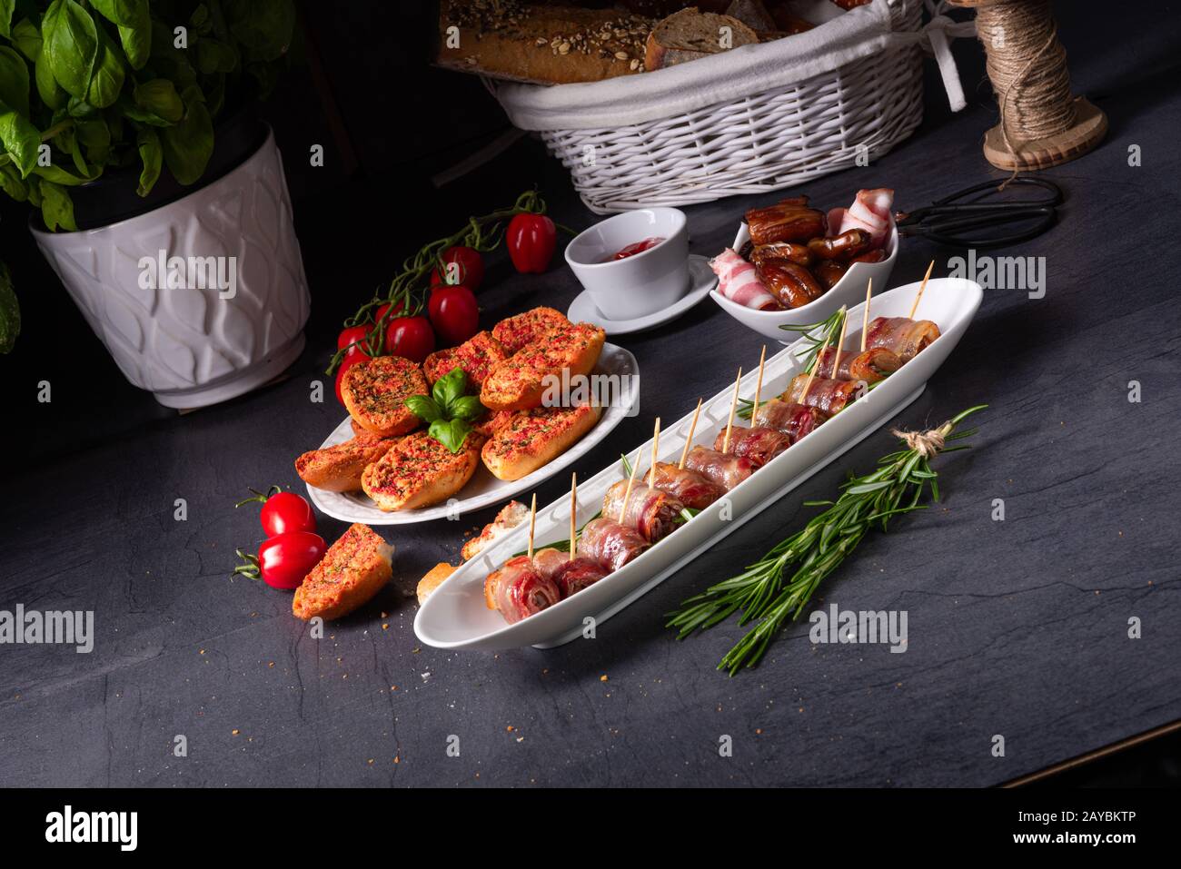dates wrapped in bacon and delicious tapas Stock Photo Alamy