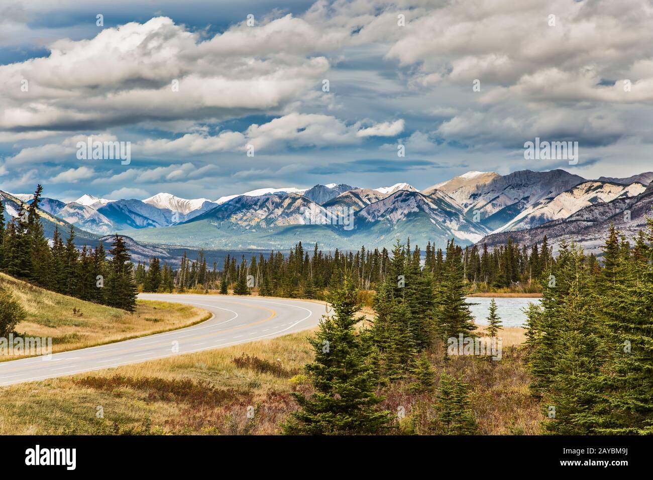 The road to distant snow-capped mountains Stock Photo