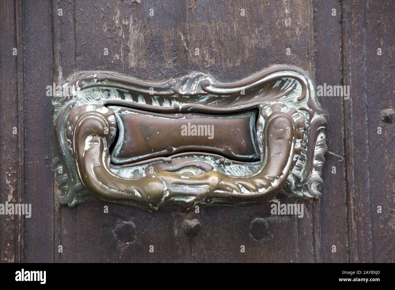 Door knocker and letter slot at the front door of a residential building  under monument protection Stock Photo - Alamy