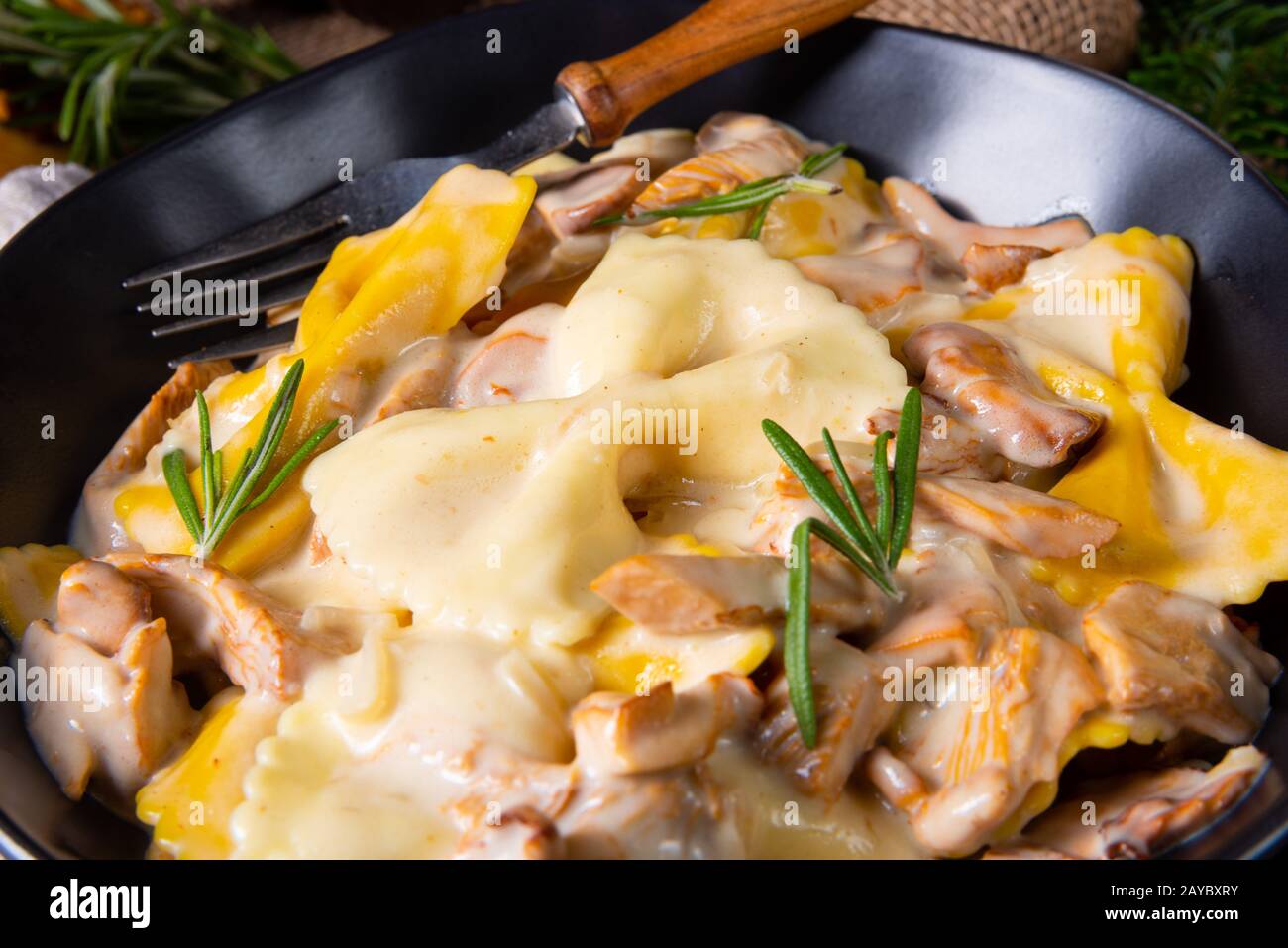 Colorful farfalle pasta with chanterelles and cream sauce Stock Photo