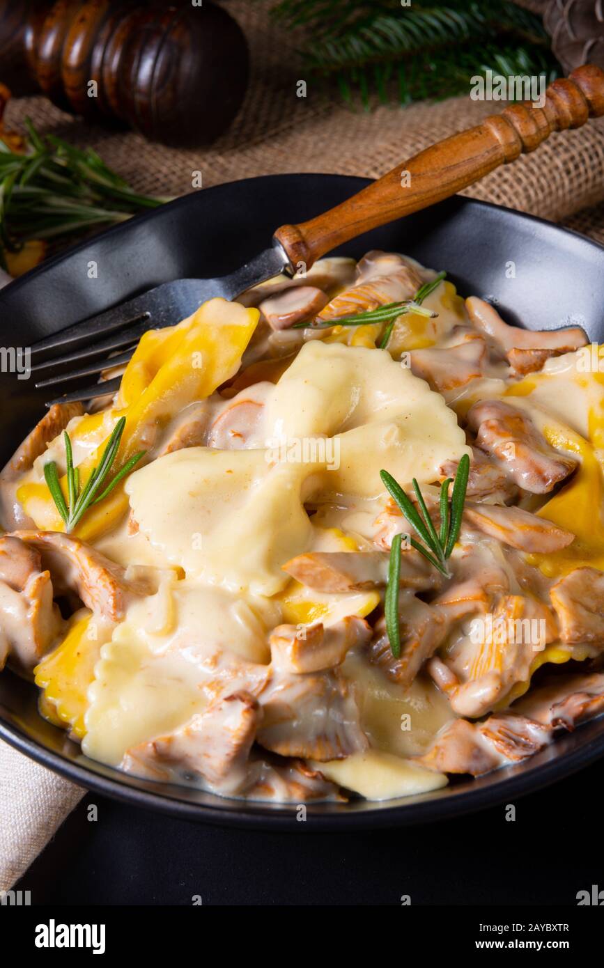 Colorful farfalle pasta with chanterelles and cream sauce Stock Photo