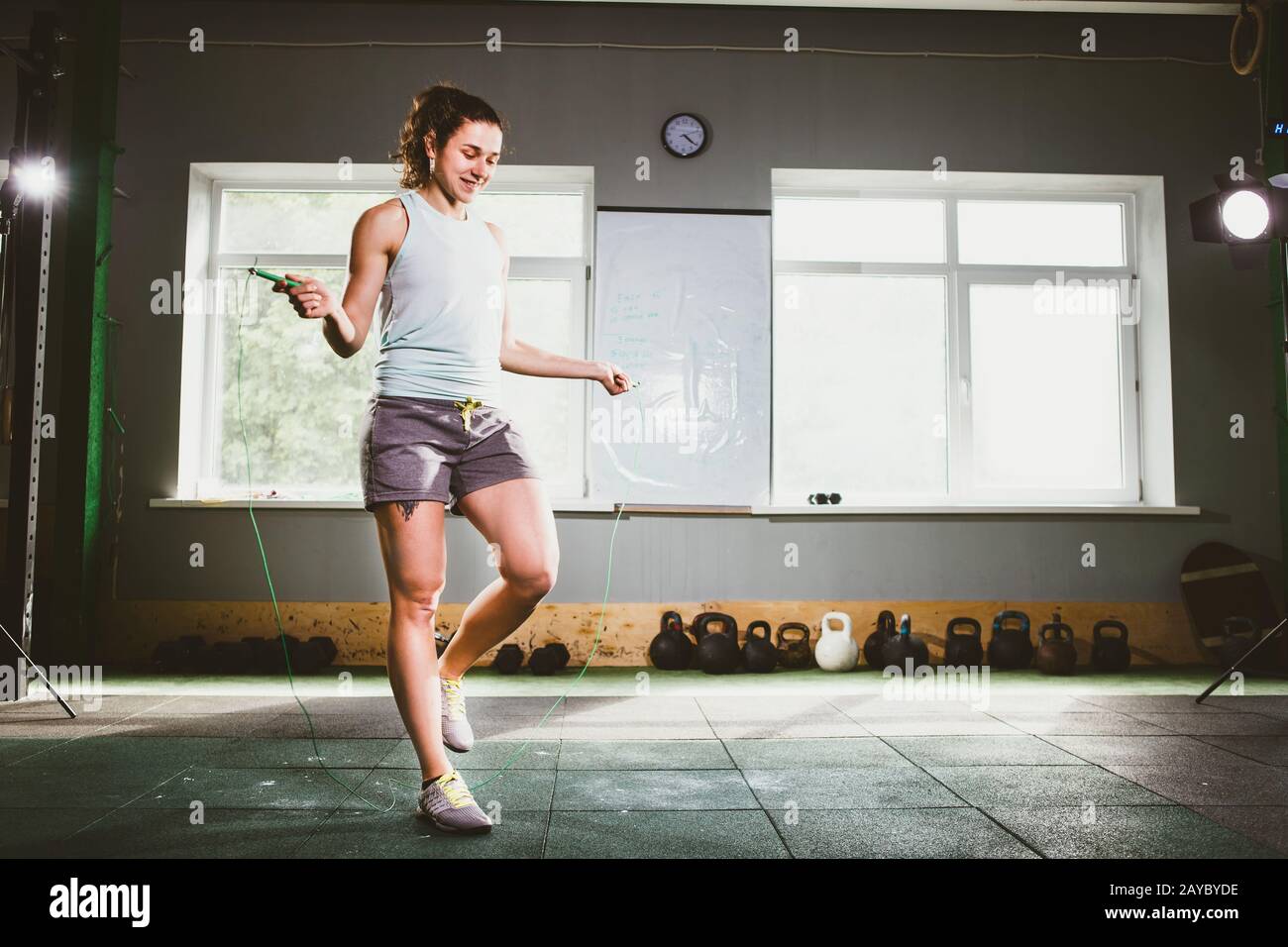 Young Caucasian smiling woman holding a skipping rope - Health and Fitness Concept Stock Photo