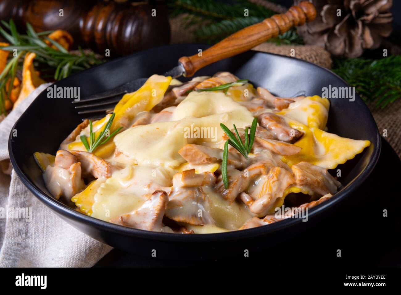 Colorful farfalle pasta with chanterelles and cream sauce Stock Photo