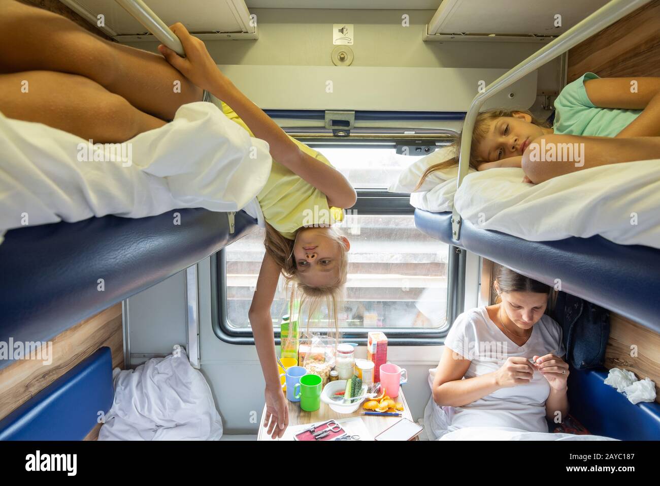 Children are tired of riding in a reserved seat train car without air conditioning for a long time Stock Photo