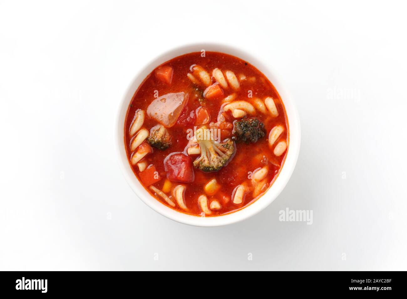 minestrone vegetables tomato soup with pasta closeup isolated on white background Stock Photo