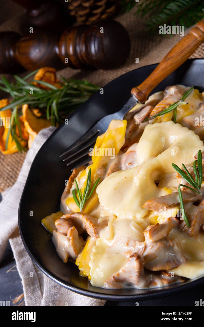 Colorful farfalle pasta with chanterelles and cream sauce Stock Photo