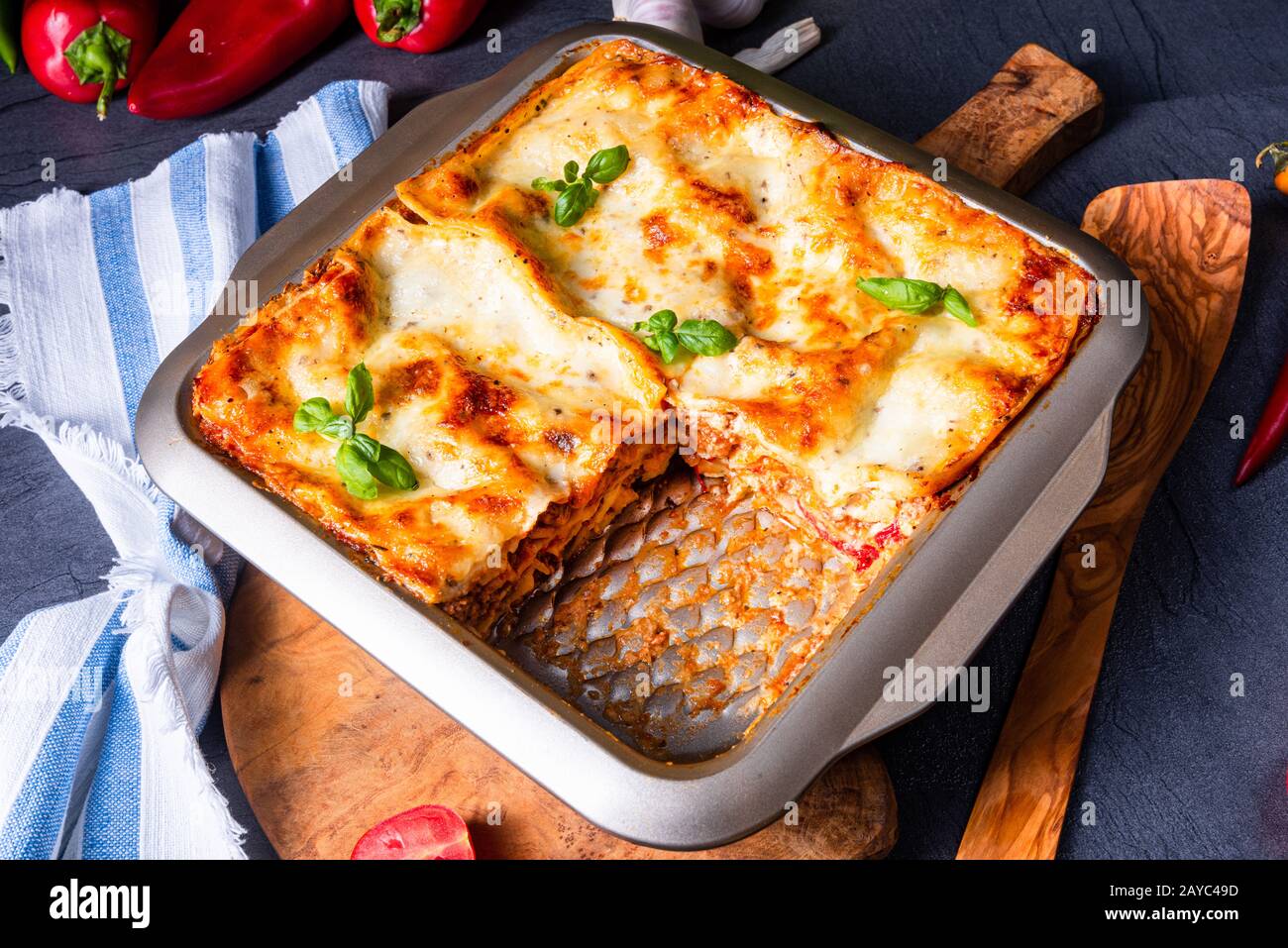 rustic spicy lasagne with basil on the tin Stock Photo - Alamy