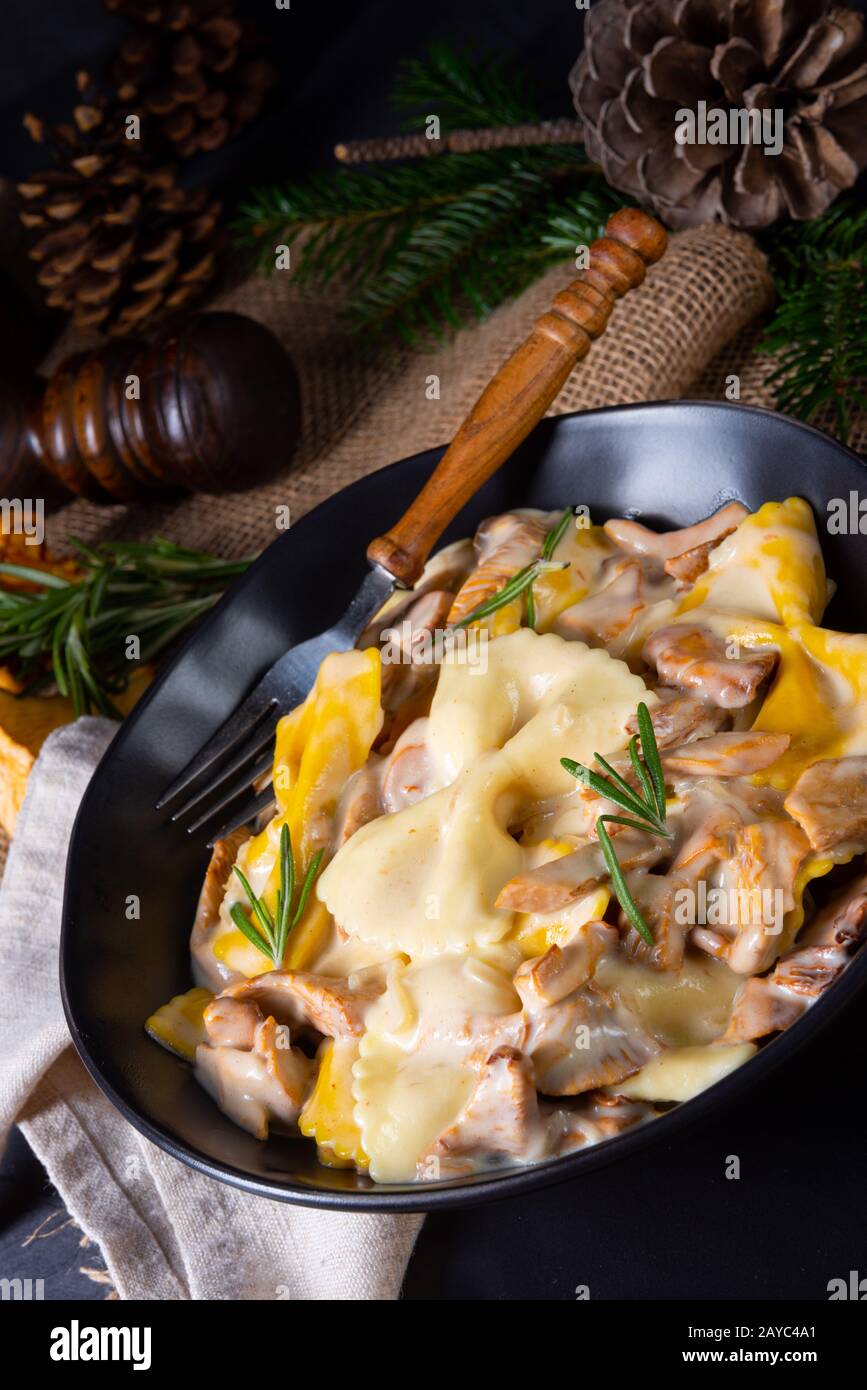 Colorful farfalle pasta with chanterelles and cream sauce Stock Photo