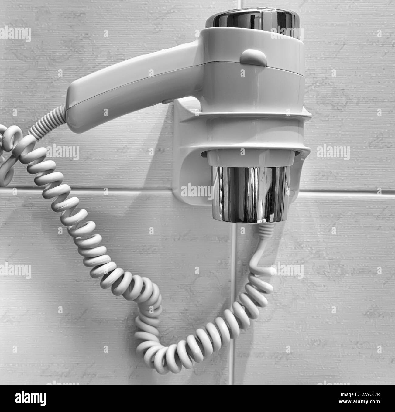 Small hair dryer on the bathroom wall Stock Photo Alamy
